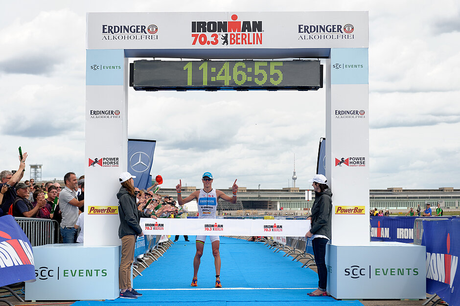 Winner of the Ironman 70.3 Berlin Michael Raelert crossing the finish line at Tempelhofer Feld. SCC EVENTS organised this event in 2013 as part of an international triathlon competition series. ©Petko Beier / SCC EVENTS